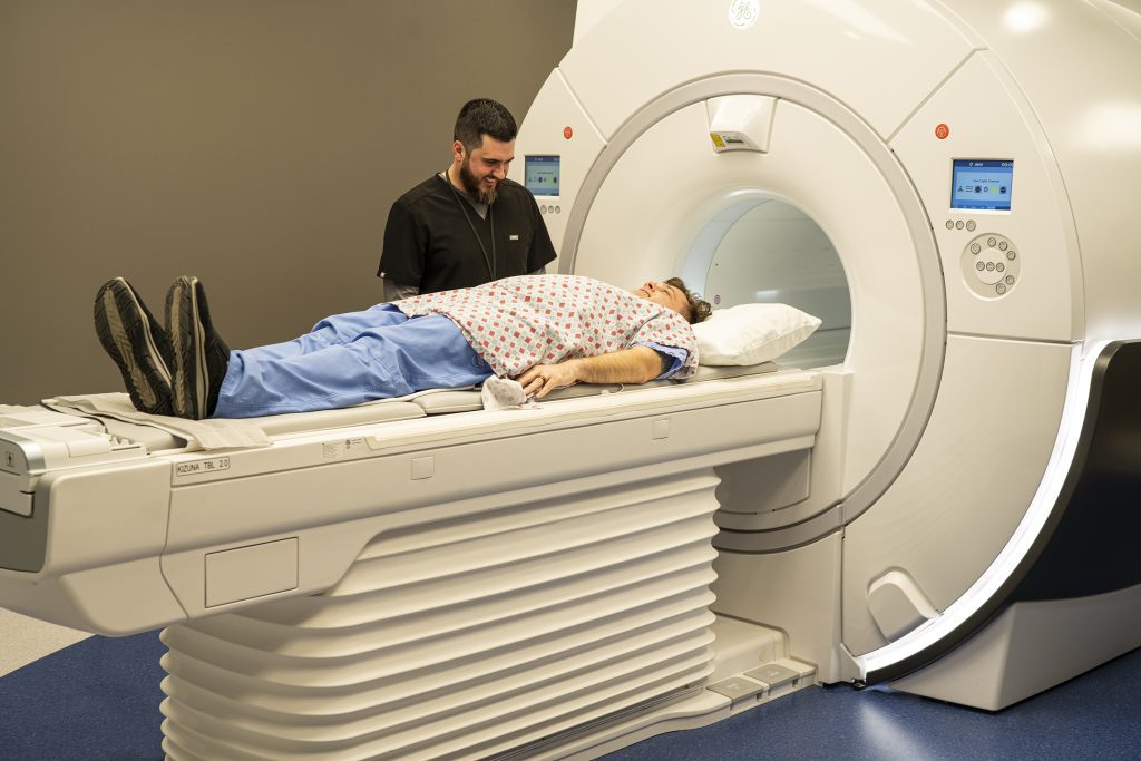 MRI Tech helping Patient as they prepare to get an MRI Scan